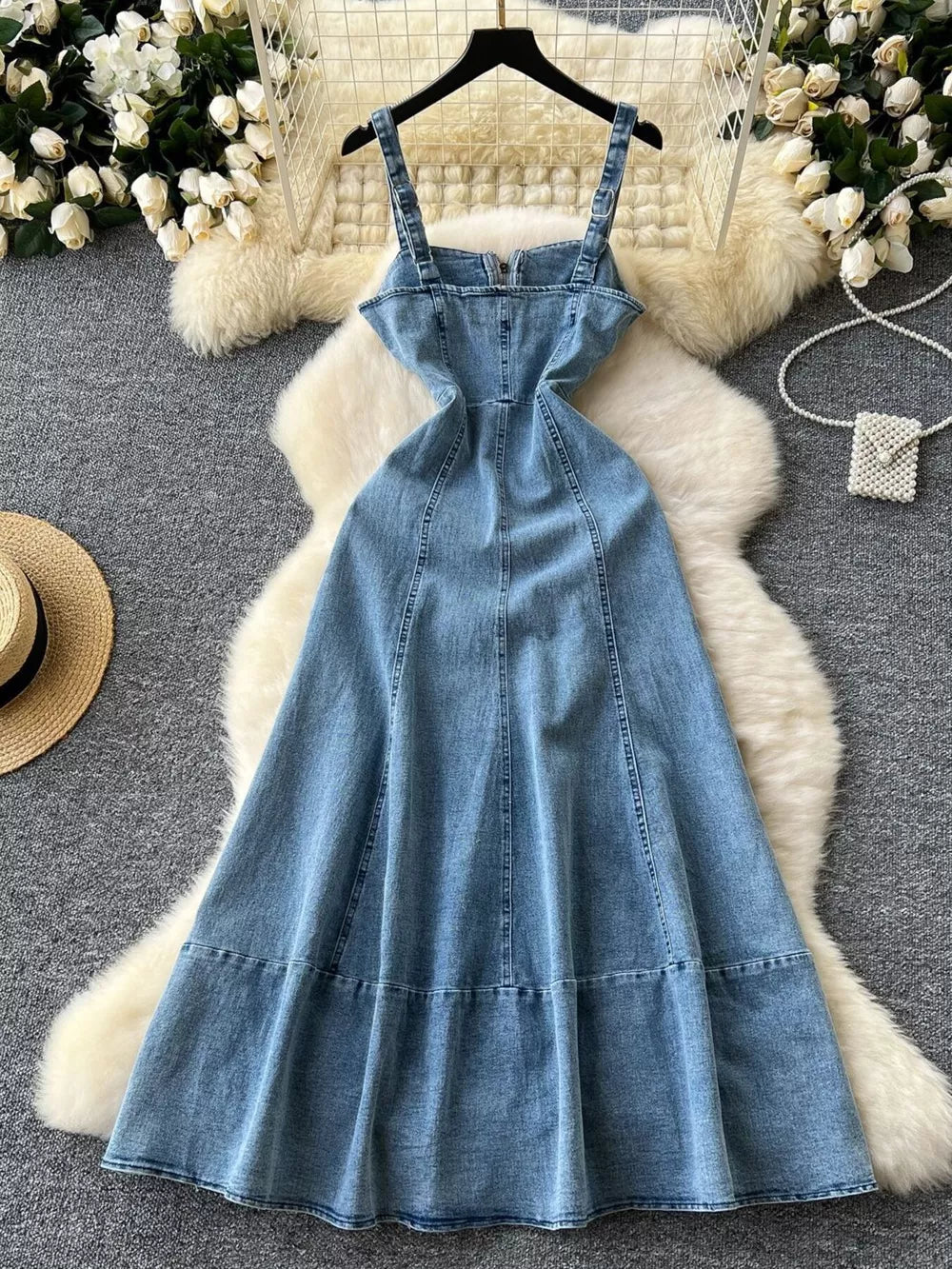 Blue denim A-line dress with zipper detail, square neckline, and adjustable straps.