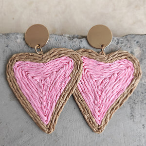 Pink woven heart statement earrings with gold disc tops.