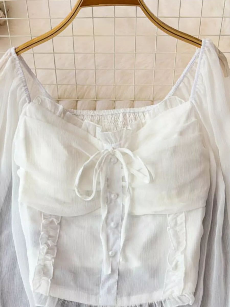 White maternity blouse with ruffled sleeves, square neckline, button front, and tie bow detail.