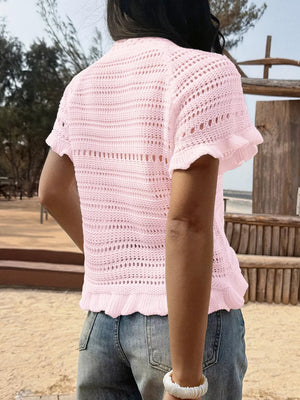 Pink knit top with short ruffled sleeves and hem, open stitch detail.