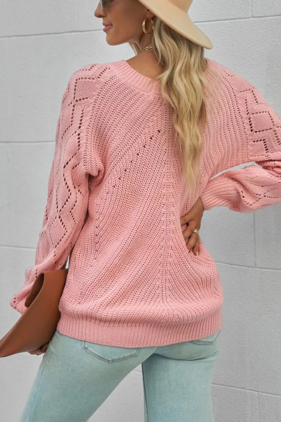 Dusty pink knit sweater with hollow-out diamond pattern on sleeves and body.