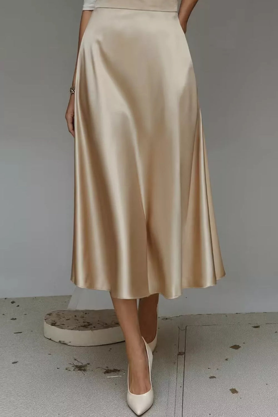 Lustrous midi skirt in khaki with a-line cut and hidden pockets.