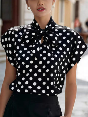 Black polka dot shirt with bow tie neck and cap sleeves