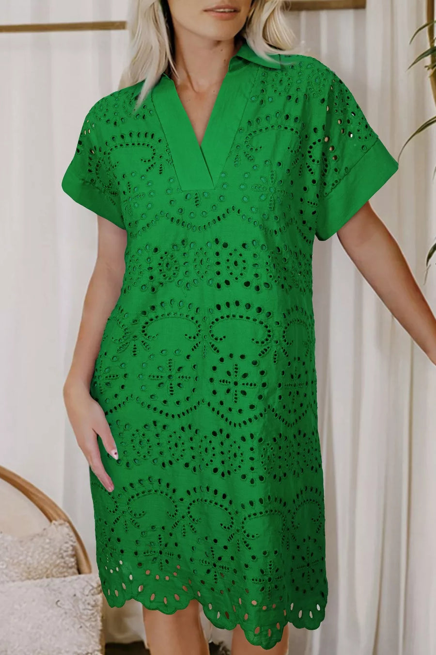 Green cotton eyelet collared dress with scalloped hem and short sleeves.