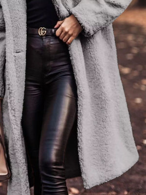 Longline teddy bear coat in gray, buttoned, with a textured fuzzy finish.