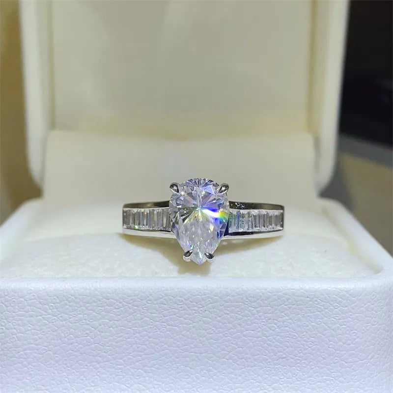 Silver pear cut moissanite ring with baguette accents