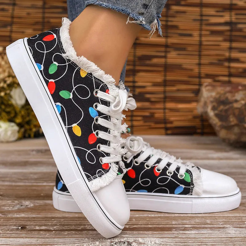 Black canvas sneakers with string light pattern and fringe trim detail.