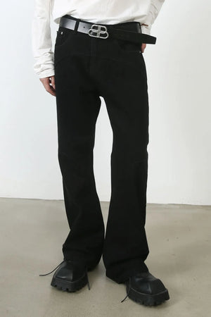 Black flared denim trousers with seam detail and a wide leg.