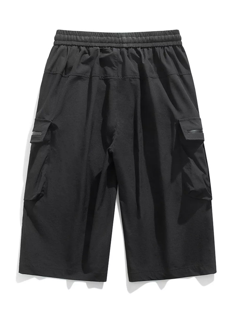 Black cargo shorts with elastic waist and zippered pockets.