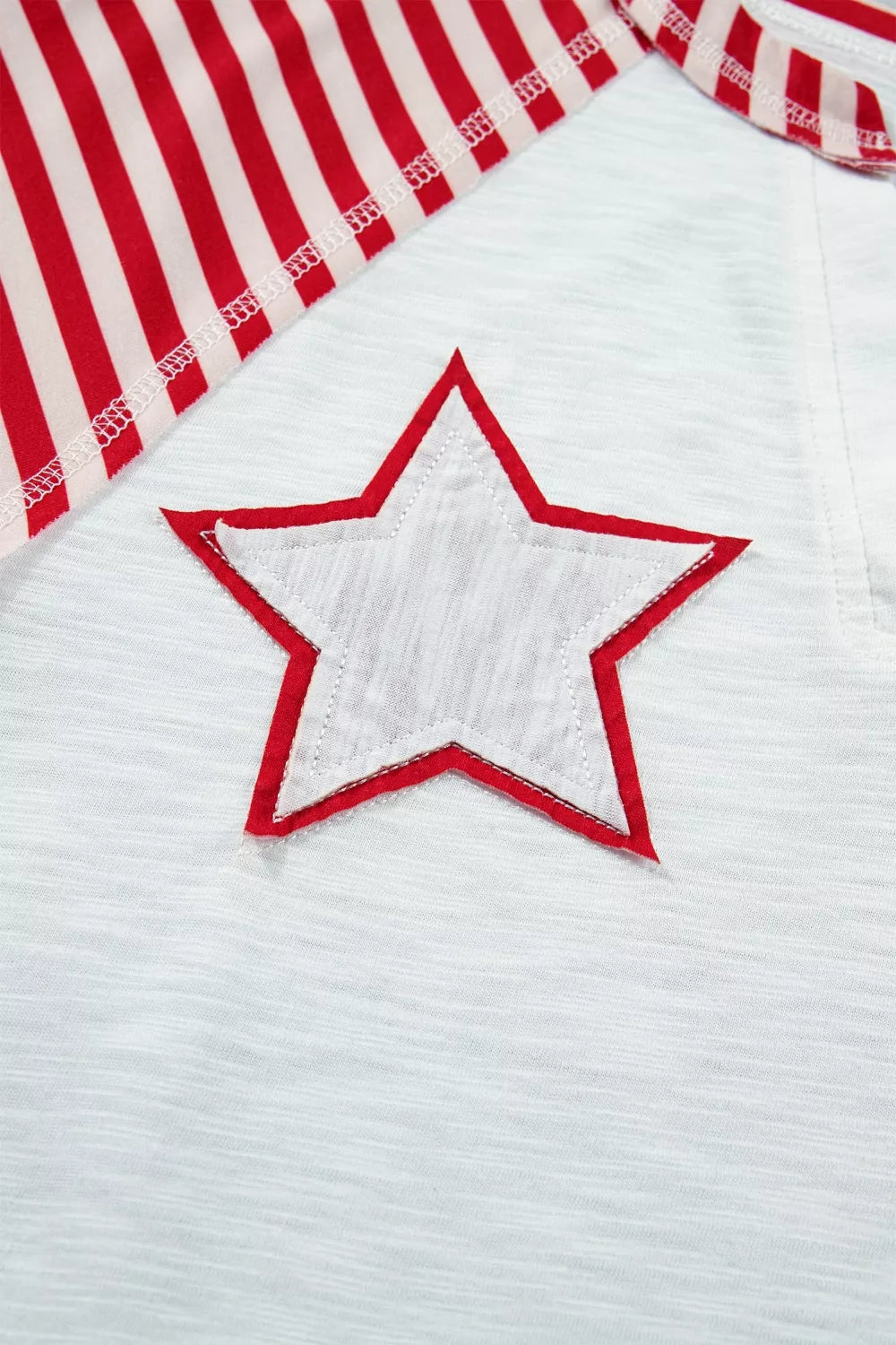 White polyester t-shirt with red star applique and red & white striped sleeves.