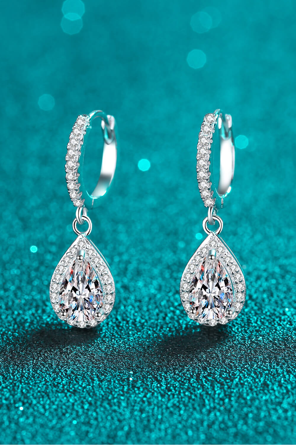 Silver pavé halo teardrop hoop earrings with clear cubic zirconia stones.