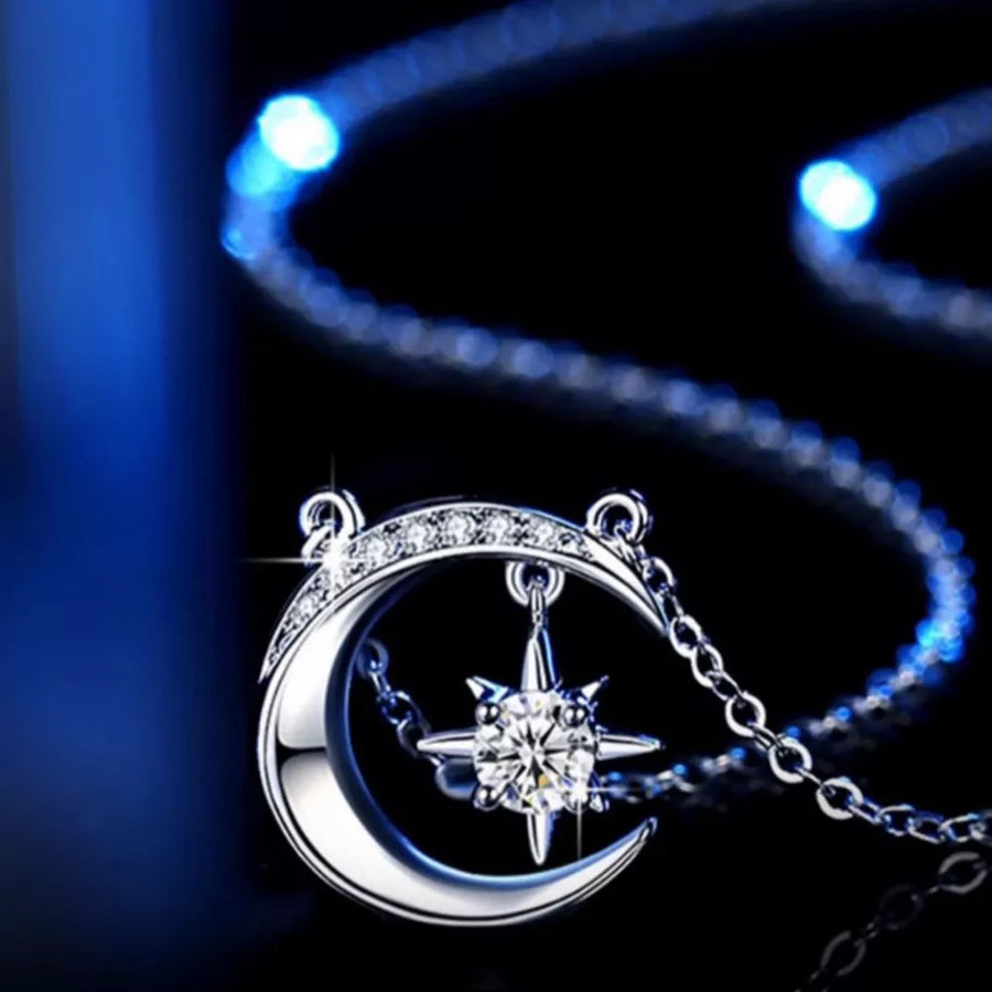 Celestial moissanite crescent necklace with star charm, silver chain.
