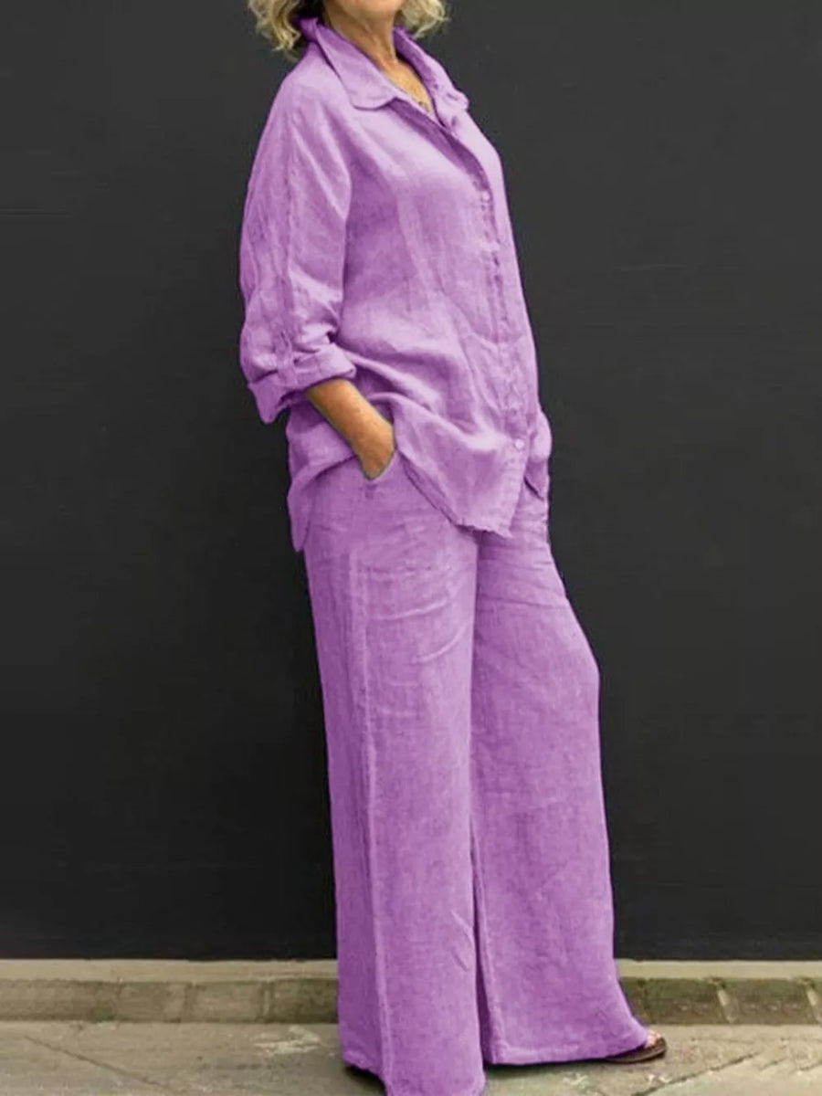 Purple relaxed two-piece set with buttoned collared top and wide-leg pants.