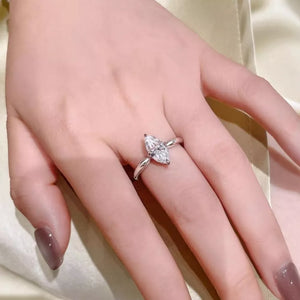 Silver ring with marquise cut diamond on a hand with taupe nail polish