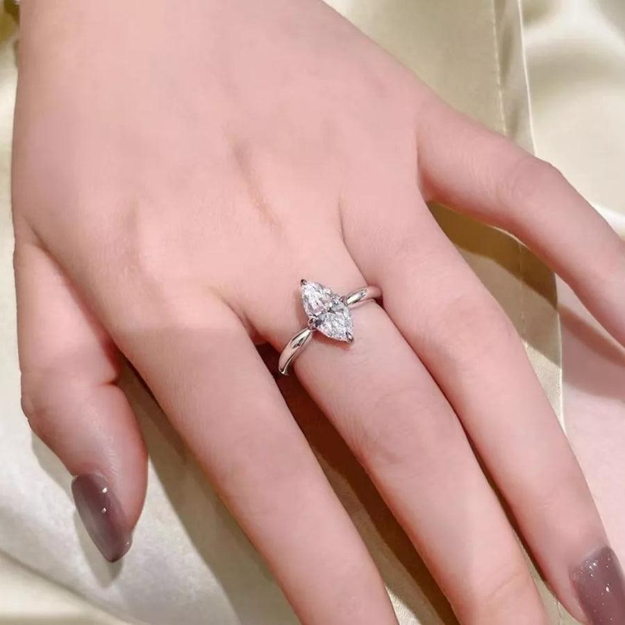 Silver ring with marquise cut diamond on a hand with taupe nail polish