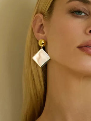 earrings in gold featuring geometric design and drop fit