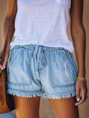 denim shorts in light blue featuring raw hem and relaxed fit