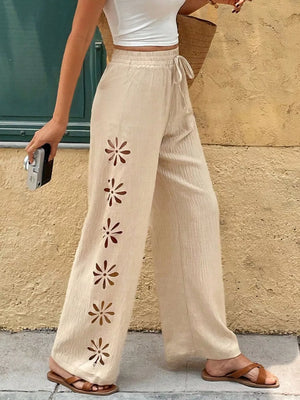 Beige linen wide leg pants with floral cutouts and drawstring waist