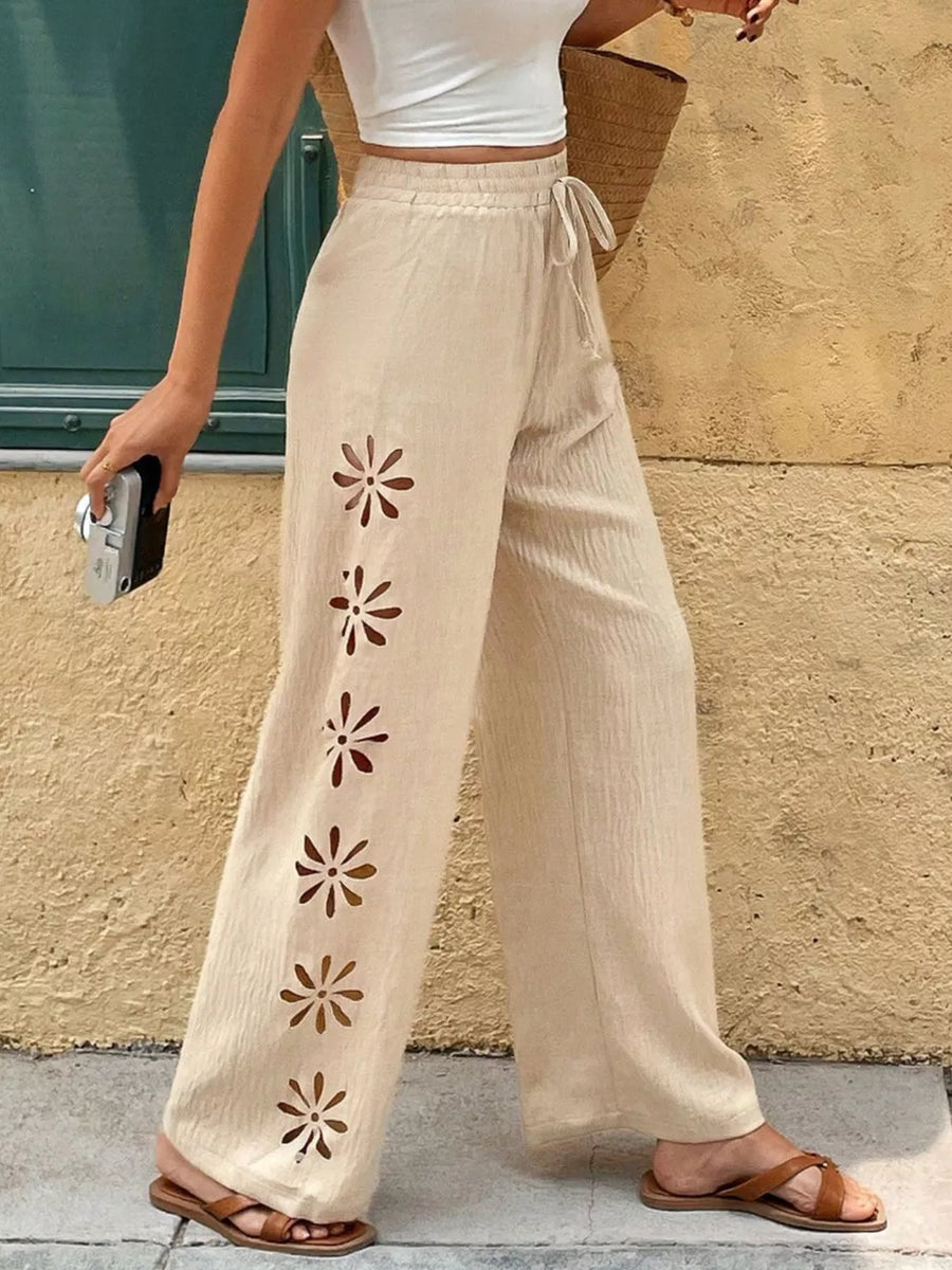Beige linen wide leg pants with floral cutouts and drawstring waist