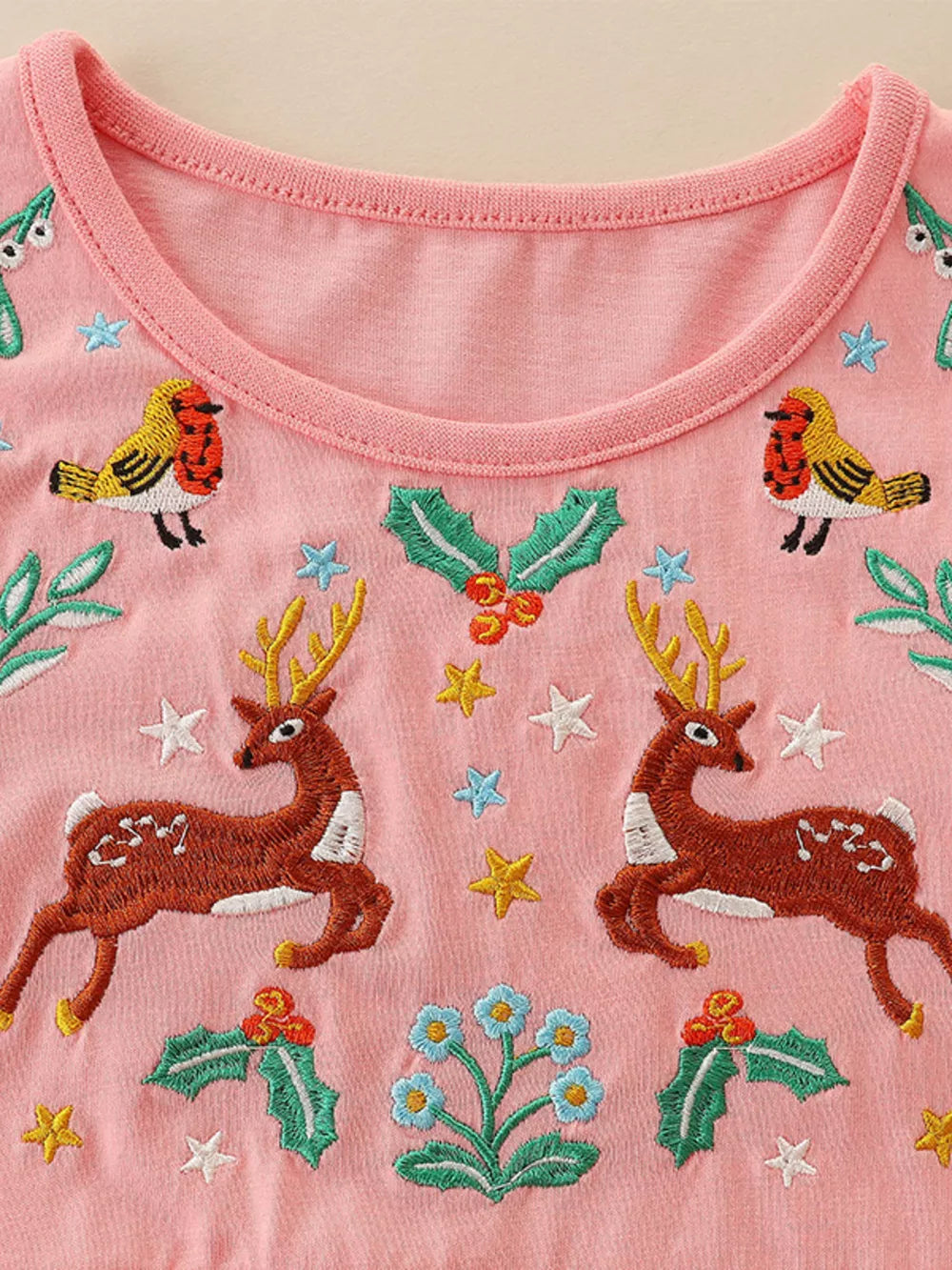 Pink cotton toddler dress with embroidered deer, birds, holly and flowers.