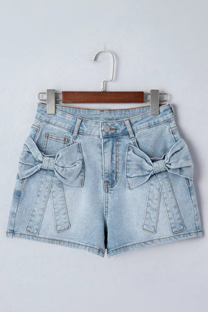 Light wash denim shorts with bow embellishments on pockets and button fly.