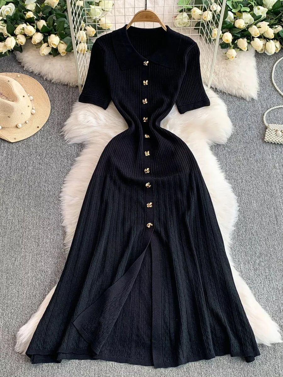Black ribbed knit midi dress with collar, short sleeves, button detail and front slit.