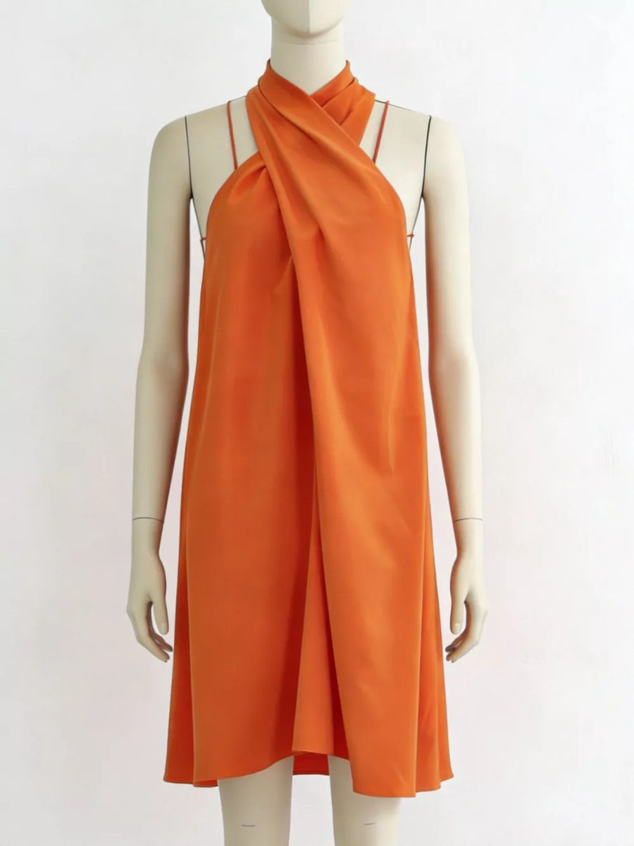 Tangerine criss-cross halter mini dress with a backless design and a-line cut.