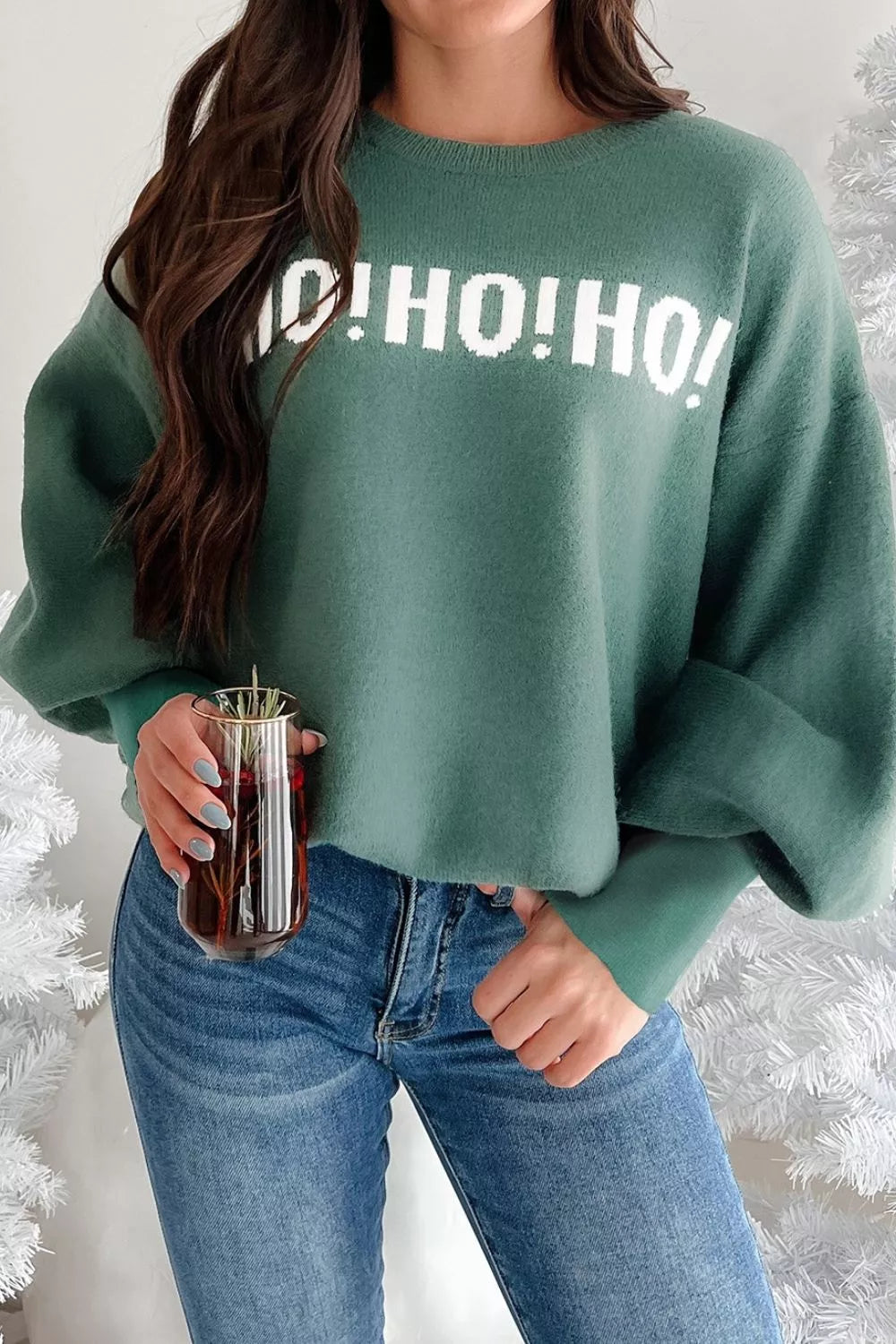 Green graphic holiday sweater with white "O! HO! HO!" text, long sleeves, crewneck, and relaxed fit.