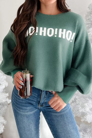 Green graphic holiday sweater with white "O! HO! HO!" text, long sleeves, crewneck, and relaxed fit.