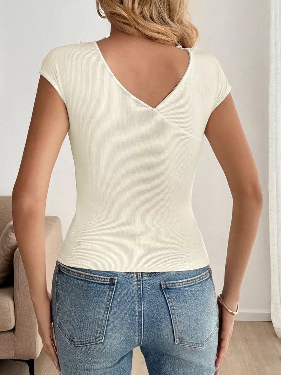 Ribbed knit v-neck t-shirt in cream with short sleeves and a wrap detail.