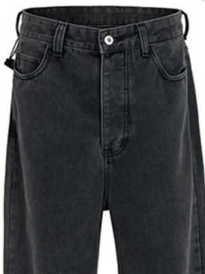 Baggy dark wash denim jeans with a sculpted hemline detail.