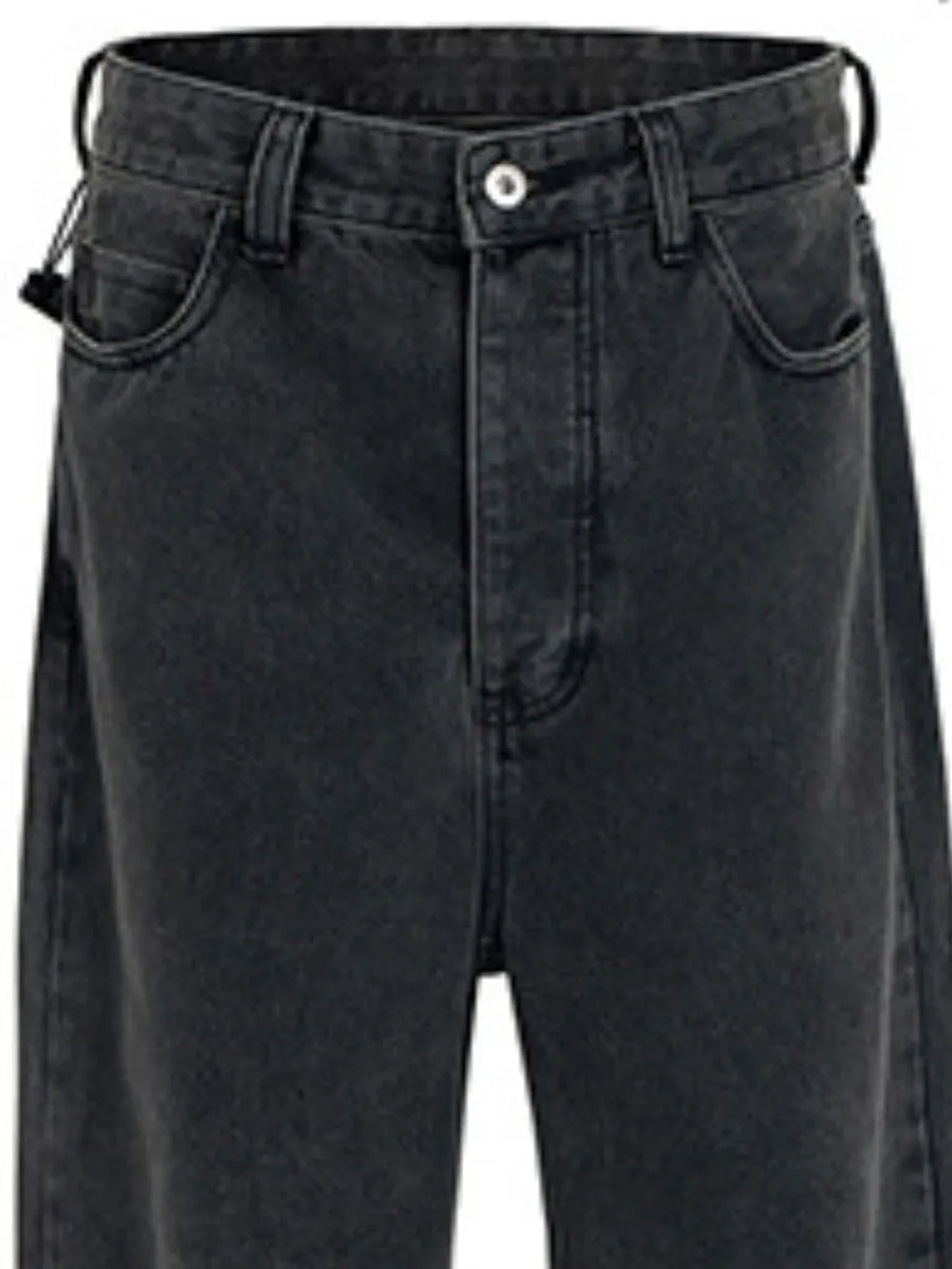 Baggy dark wash denim jeans with a sculpted hemline detail.
