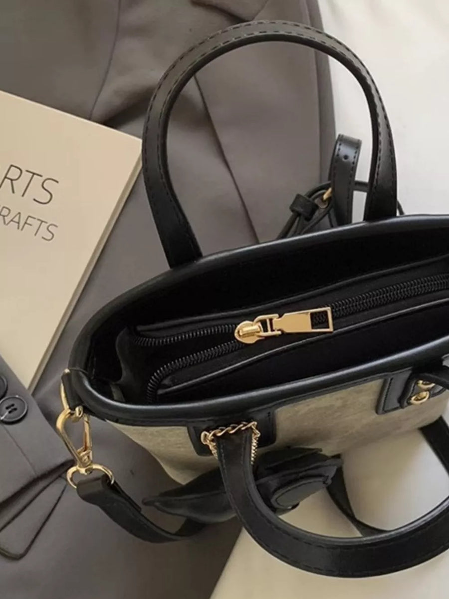Premium mini pu leather chest bag in black with gold hardware and a textured detail.