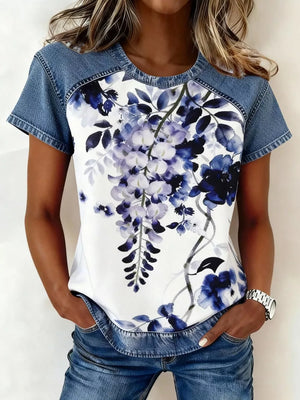 Denim patchwork short sleeve shirt with a white floral print and blue accents.