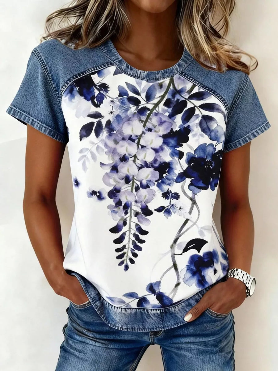 Denim patchwork short sleeve shirt with a white floral print and blue accents.
