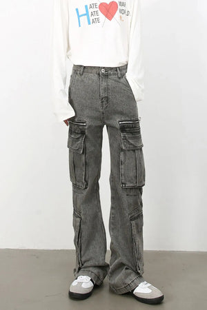 Acid wash flared cargo jeans in medium with multiple zippered and pocket details.