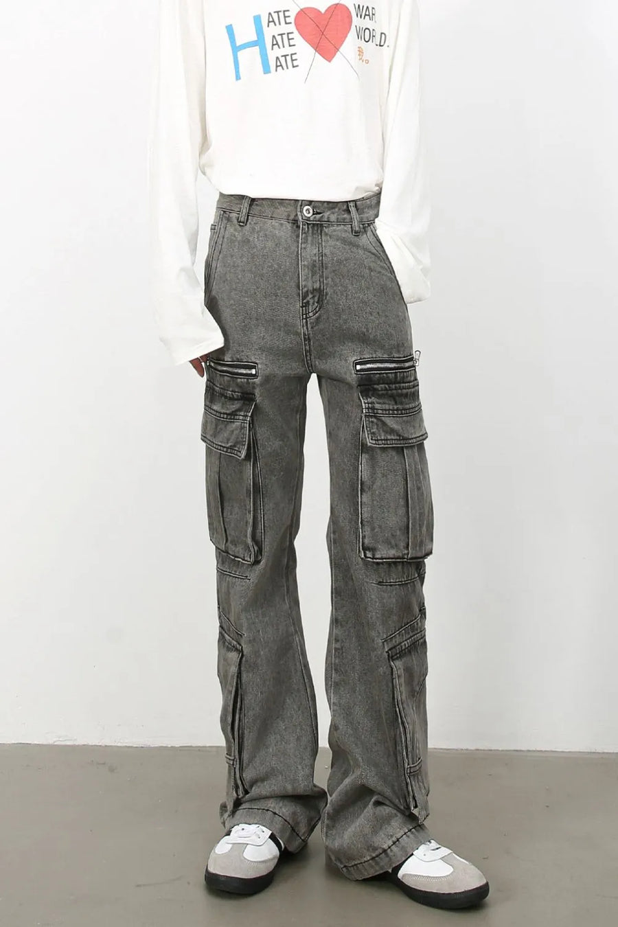 Acid wash flared cargo jeans in medium with multiple zippered and pocket details.