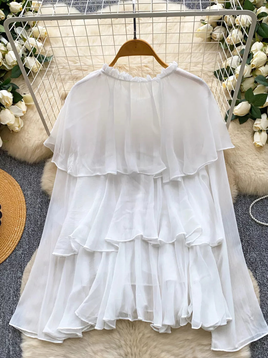 White chiffon blouse with ruffled tiers and a ruffled neckline.