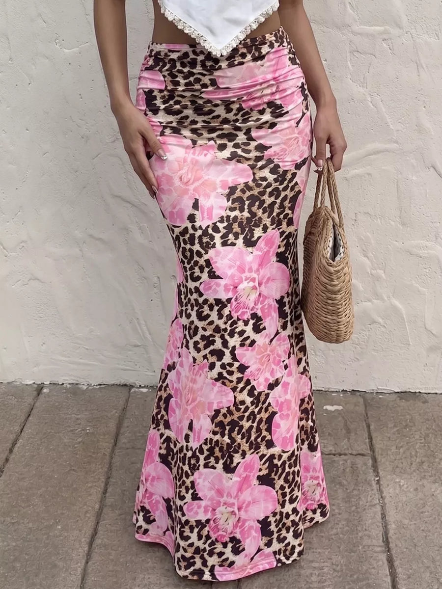 Leopard floral bodycon maxi skirt with pink flowers, ruched detail, and a flattering fit.
