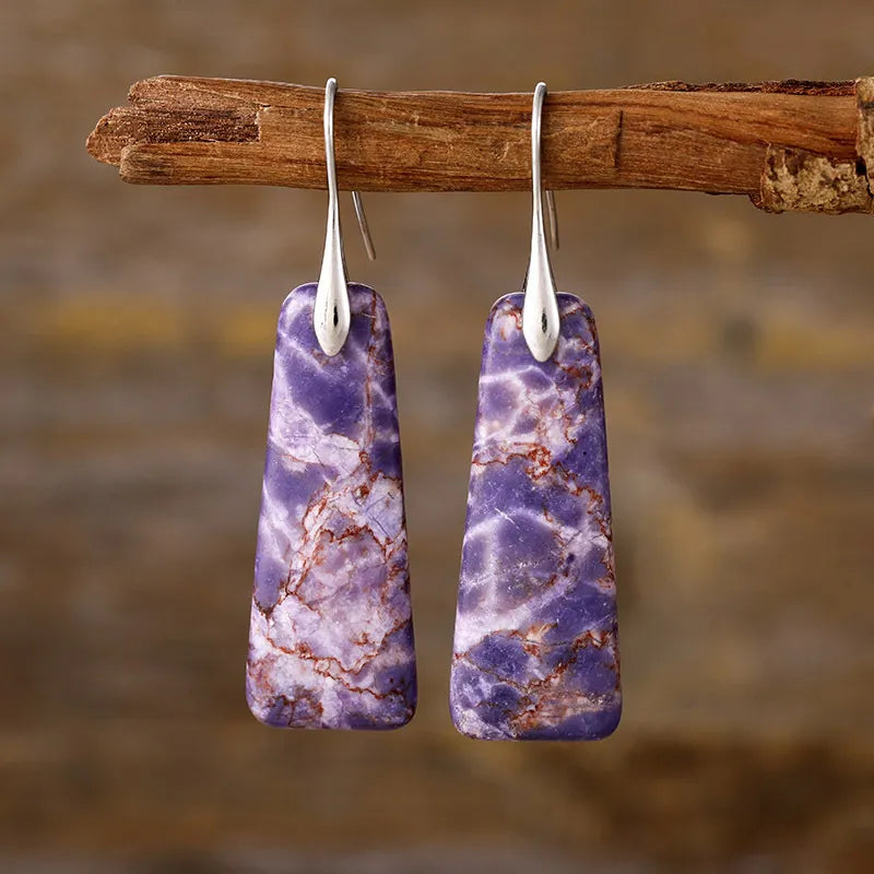 Textured purple stone drop earrings with silver hooks.