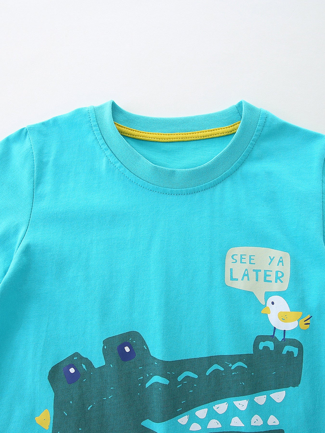 Turquoise cotton tee with crocodile graphic and bird saying See Ya Later.