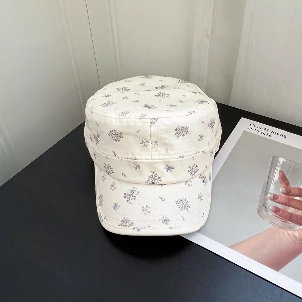 White cadet cap with a delicate blue and purple floral print.