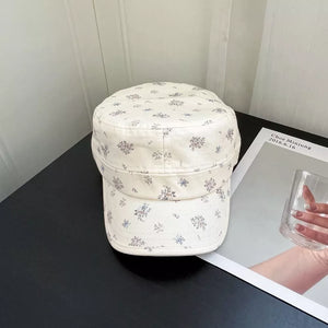 White cadet cap with a delicate blue and purple floral print.