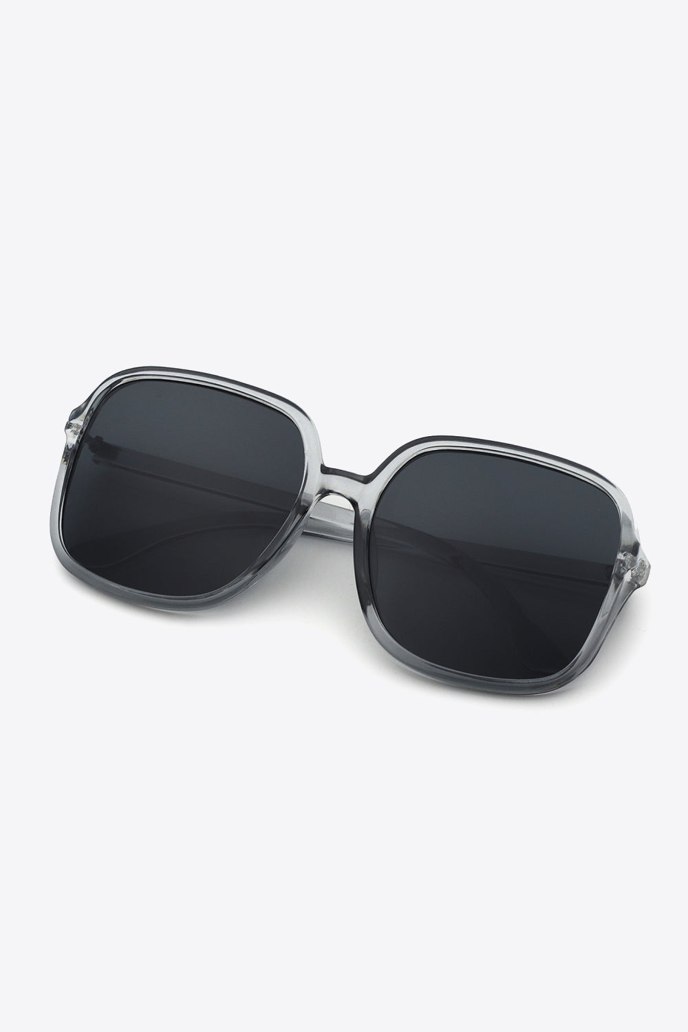 Retro-infused square frame sunglasses with clear frames and dark lenses.