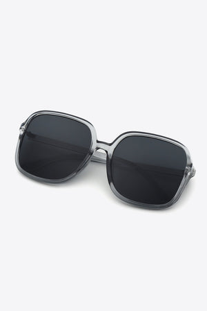 Retro-infused square frame sunglasses with clear frames and dark lenses.