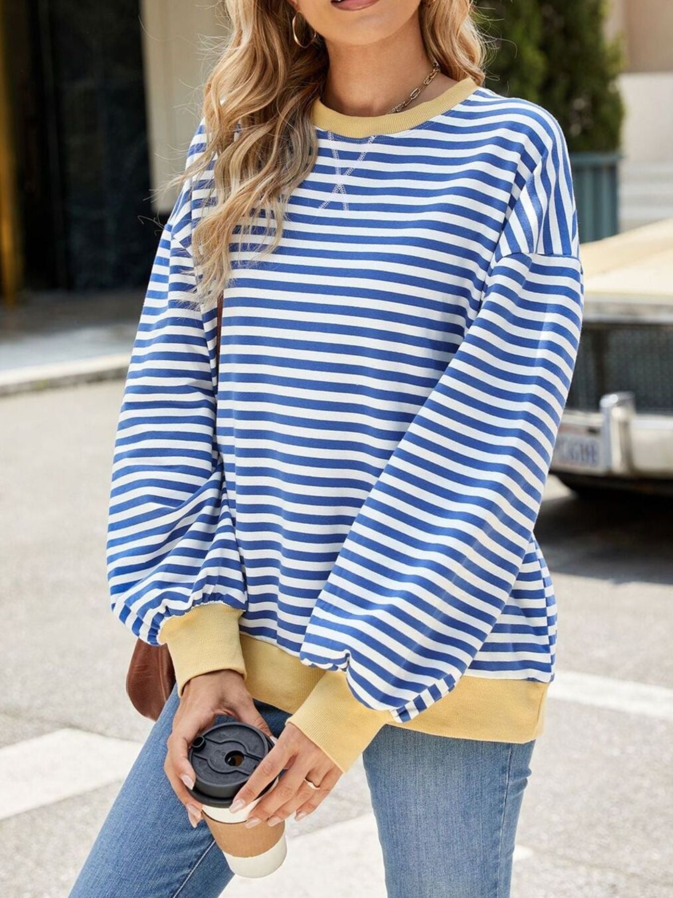 Striped crew neck sweatshirt in royal blue and white with yellow cuffs and neckline.