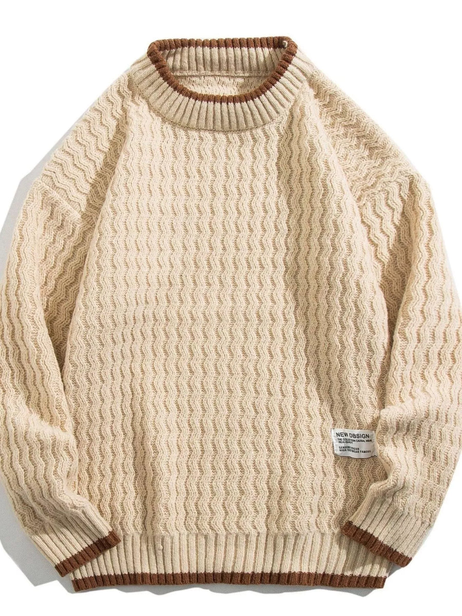 Textured knit sweater in apricot with brown trim and crew neck.