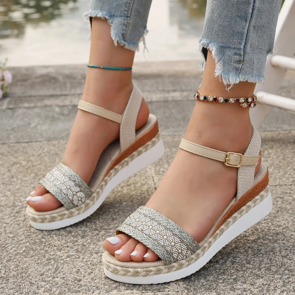 Beige embroidered espadrille platform sandals with ankle straps and buckle closure.