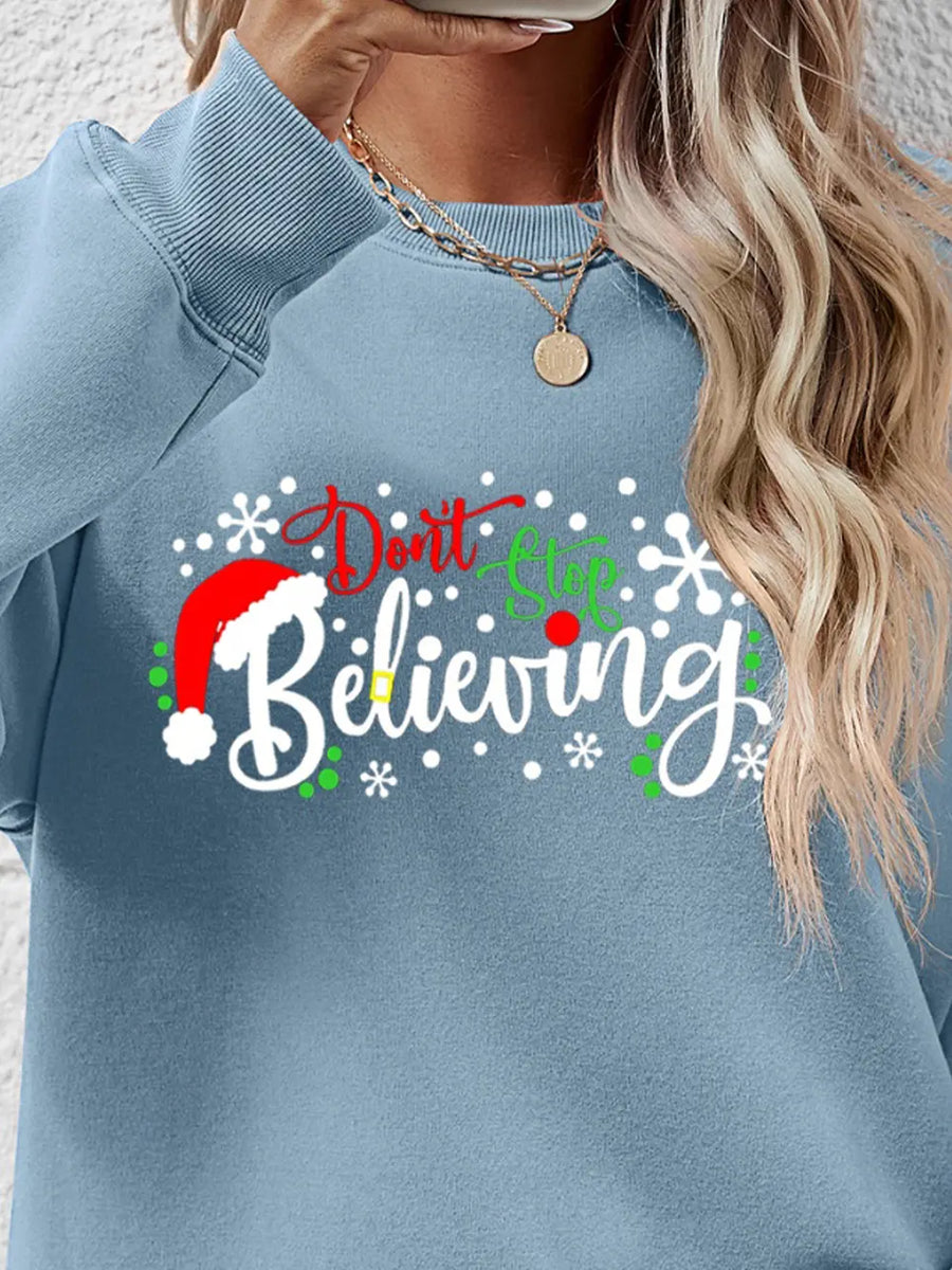 Air Force Blue long sleeve sweater with "Don't Stop Believing" graphic and Santa hat detail.