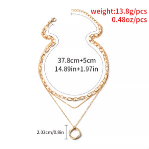 Gold layered pendant necklace with a geometric charm and adjustable chain.